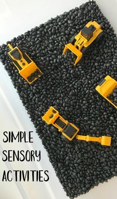 four yellow construction vehicles on black rocks with text overlay reading simple sensory activities