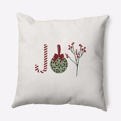 a white pillow with red and green decorations on it