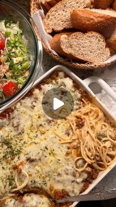 the meal is prepared and ready to be eaten on the table with bread in baskets