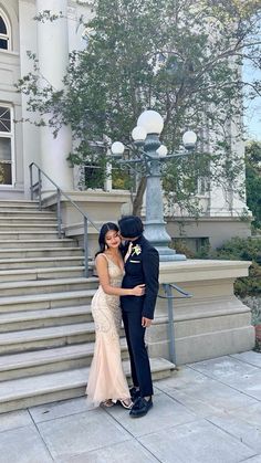 a man and woman standing in front of a building