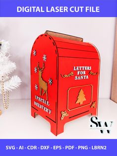 a red mailbox sitting on top of a white table next to a christmas tree