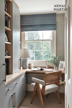 a home office with built in bookshelves, desk and chair by the window