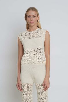 The sarah crochet is a relaxed shell top in a modern graphic open-lace stitch with coverage at the front bust and a playful back keyhole detail. style effortlessly back to your favorite high-waist pant or style with the matching rebecca crochet pant as a sleek knit-set.    detail:    - hand crochet in peru with love  - made from 100% peruvian cotton  - graphic open crochet  lace-stitch with filled in crochet coverage at front bust.  - crew neck at front  w/ back neck tie at back scooped out key- High Neck Crochet Top, Spring Cotton Knit Top With Crochet Lace, Knit Crochet Lace Top With Crew Neck, Beige Cotton Crochet Top With Crochet Trim, Beige Cotton Crochet Top With Trim, Beige Pointelle Knit Crochet Top, Beige Pointelle Knit Crochet Crew Neck Top, Cream Crew Neck Crochet Top With Open Knit, Chic Open Knit Lace Tops