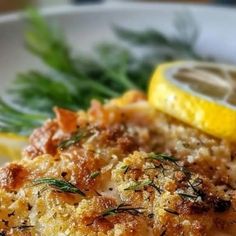 a close up of food on a plate with lemon wedges and parmesan cheese