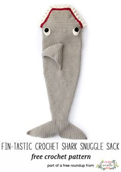 a knitted shark toy with the words fin - tastic crochet shark snuggle sack