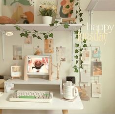 a desk with a computer, keyboard and plant on it in front of a happy horsday card