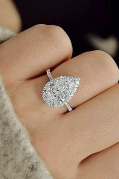 a woman's hand with a diamond ring on it