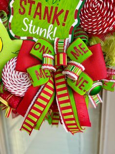 a christmas wreath with candy canes, candies and a green sign that says stank stink