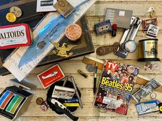 an assortment of various items on a wooden table with labels and magnets attached to them