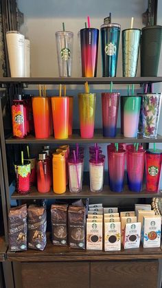 there are many different cups on the shelf