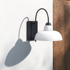 a white light hanging from the side of a wall next to a wooden paneled door