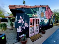 a colorful building with flowers painted on it