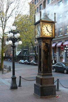 a clock tower in the middle of a city street