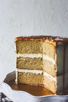 there is a piece of cake that has been cut from the cake and is on a plate