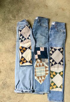 three pairs of jeans with patchwork on them