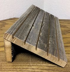 a wooden bench sitting on top of a hard wood floor