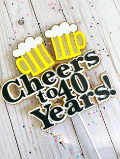 a cake topper that says cheers to 40 years