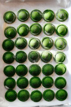 there are many green balls on the tray