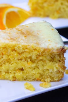 a piece of cake sitting on top of a white plate next to an orange slice