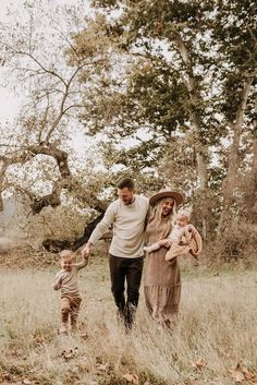 a man, woman and child walking through a field