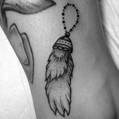 a black and white photo of a feather with a bead on it's head