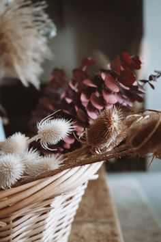 dried flowers in a wicker basket on a table