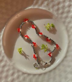 a white plate topped with a beaded necklace and charms