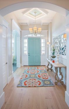 a blue door is in the middle of a hallway with a rug on the floor