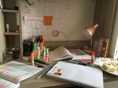 the desk is cluttered with pens, papers, and other office supplies on it