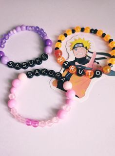 two bracelets with one beaded and the other has a cartoon character on it