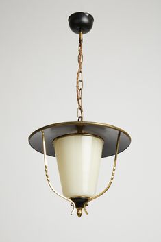 a black and gold chandelier hanging from a ceiling fixture with white glass shades