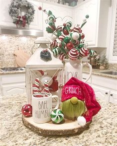 a kitchen counter with christmas decorations on it and a gnome figurine in the center