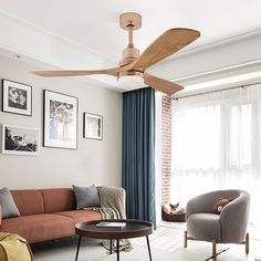 a living room filled with furniture and a ceiling fan