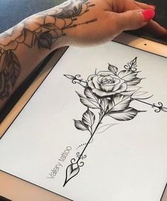 a woman's arm with tattoos on it and an image of a rose in the middle