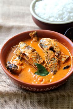 an orange bowl filled with some type of curry