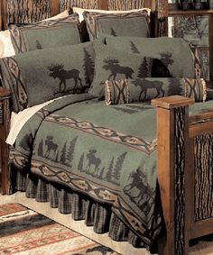 the bed is made up with moose and pine trees on it's coverlet