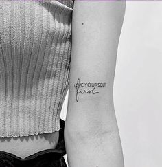 a woman with a tattoo on her arm that says, you're yourself here