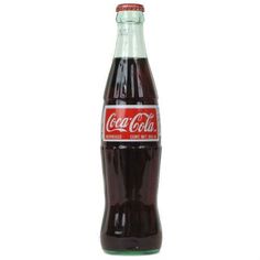 a bottle of coca cola sitting on top of a white table