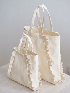 two white bags sitting on top of a table