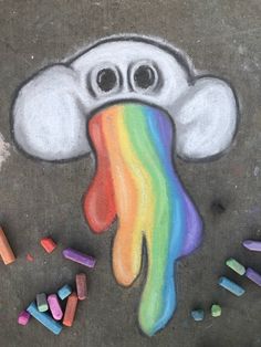 a chalk drawing of a cloud with a rainbow colored substance in the center and crayons surrounding it