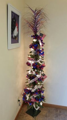 a christmas tree decorated with red, white and blue ribbons