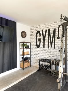 there is a gym room with white bricks on the wall