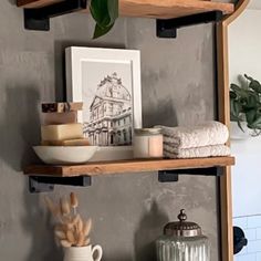 two shelves with towels, soap and other items on them in a room that looks like it could be used as a bathroom