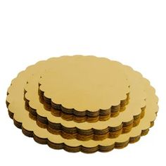 gold colored coasters are stacked on top of each other in the shape of circles