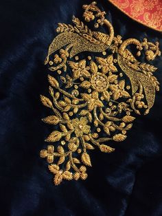 an embroidered jacket with gold thread work on it