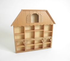 a wooden doll house with shelves and doors