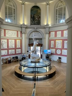 the inside of a building with sculptures on display