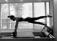 a woman is doing exercises on an exercise machine