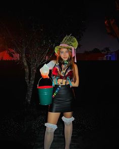 a woman dressed in costume holding a bucket