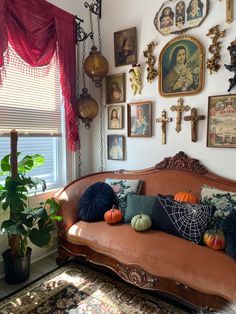 a living room filled with furniture and pictures on the wall